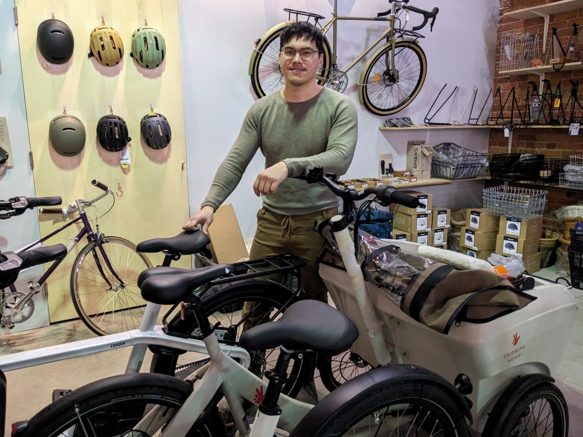 Owner Lamar next to a couple of the cargo bikes they carry.